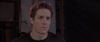 Movie still from “About a Boy” (2002), directed by Chris Weitz – A person wearing a black t - shirt; Close Up shot, Low angle