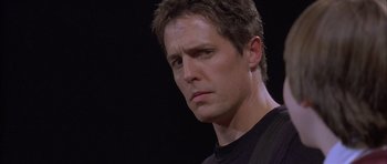 Movie still from “About a Boy” (2002), directed by Chris Weitz – A person wearing a black t - shirt; Close Up shot, Low angle
