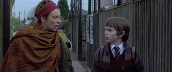 Movie still from “About a Boy” (2002), directed by Chris Weitz – Two young people standing next to each other on a sidewalk; Close Up shot, Over the shoulder angle