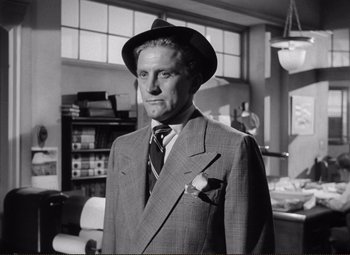 Movie still from “Ace in the Hole” (1951), directed by Billy Wilder – An older man wearing a suit and hat; Medium shot, Low angle