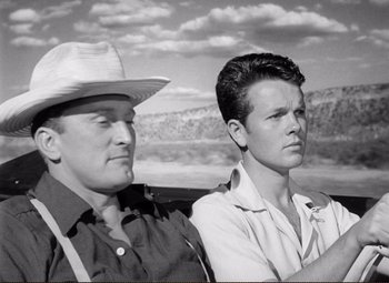 Movie still from “Ace in the Hole” (1951), directed by Billy Wilder – A man and a woman sitting next to each other; Medium shot, Low angle