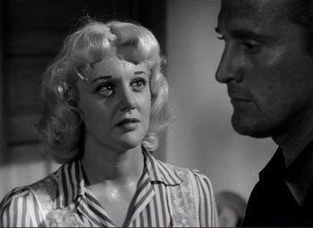 Movie still from “Ace in the Hole” (1951), directed by Billy Wilder – An old photo of a man and a woman looking at each other; Close Up shot, Low angle