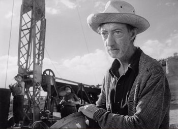 Movie still from “Ace in the Hole” (1951), directed by Billy Wilder – A man wearing a cowboy hat in front of an airplane; Close Up shot, Low angle