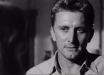 Movie still from “Ace in the Hole” (1951), directed by Billy Wilder – Black and white photograph of a man in a white shirt; Close Up shot, Low angle