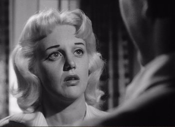 Movie still from “Ace in the Hole” (1951), directed by Billy Wilder – An old black and white photo of a woman looking into a mirror; Close Up shot, Low angle