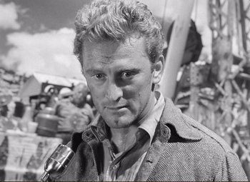 Movie still from “Ace in the Hole” (1951), directed by Billy Wilder – Black and white photograph of a man with a microphone; Close Up shot, Low angle