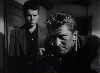 Movie still from “Ace in the Hole” (1951), directed by Billy Wilder – Two men are standing in front of each other; Close Up shot, Low angle