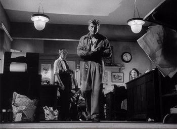 Movie still from “Ace in the Hole” (1951), directed by Billy Wilder – A black and white photo of a man and a woman; Wide shot, Low angle