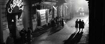 Movie still from “Adam Resurrected” (2008), directed by Paul Schrader – A black - and - white photo of people walking on a street; Extreme Wide shot, High angle