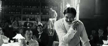 Movie still from “Adam Resurrected” (2008), directed by Paul Schrader – Black and white photograph of a man with a mustache; Medium shot, Low angle