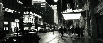 Movie still from “Adam Resurrected” (2008), directed by Paul Schrader – A black and white photo of a city street at night; Wide shot, Low angle
