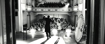 Movie still from “Adam Resurrected” (2008), directed by Paul Schrader – A man and a woman are performing on stage; Wide shot, Low angle