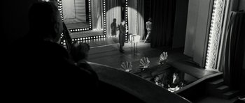 Movie still from “Adam Resurrected” (2008), directed by Paul Schrader – A black - and - white photo of a man on a stage; Extreme Wide shot, High angle