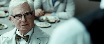 Movie still from “Adam Resurrected” (2008), directed by Paul Schrader – A man sitting at a table with a plate in front of him; Close Up shot, Over the shoulder angle