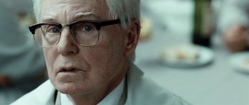 Movie still from “Adam Resurrected” (2008), directed by Paul Schrader – An older man wearing glasses and a white shirt; Close Up shot, Over the shoulder angle