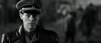 Movie still from “Adam Resurrected” (2008), directed by Paul Schrader – A man in a military uniform is looking at the camera; Close Up shot, Over the shoulder angle