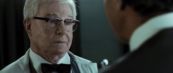 Movie still from “Adam Resurrected” (2008), directed by Paul Schrader – An older man wearing glasses and a bow tie; Close Up shot, Over the shoulder angle