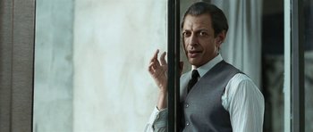 Movie still from “Adam Resurrected” (2008), directed by Paul Schrader – A man wearing a suit and tie standing next to a window; Close Up shot, Low angle