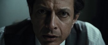 Movie still from “Adam Resurrected” (2008), directed by Paul Schrader – A man's face in a suit and tie; Extreme Close Up shot, Low angle
