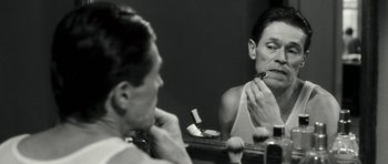 Movie still from “Adam Resurrected” (2008), directed by Paul Schrader – A woman brushing her teeth in the mirror; Close Up shot, Over the shoulder angle