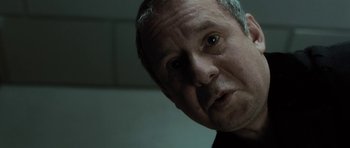 Movie still from “Adam Resurrected” (2008), directed by Paul Schrader – A man's face in a dark room; Close Up shot, Over the shoulder angle