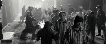 Movie still from “Adam Resurrected” (2008), directed by Paul Schrader – A black and white photo of a group of people in prison uniforms; Medium shot, High angle