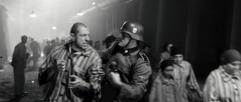 Movie still from “Adam Resurrected” (2008), directed by Paul Schrader – A man in a helmet is talking to another man; Medium shot, Over the shoulder angle