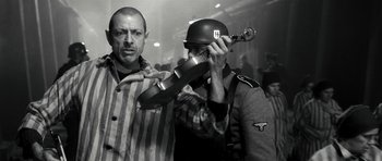 Movie still from “Adam Resurrected” (2008), directed by Paul Schrader – Two men in nazi garb are playing a musical instrument; Medium shot, Low angle