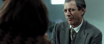 Movie still from “Adam Resurrected” (2008), directed by Paul Schrader – A man wearing a suit and tie talking to a woman; Close Up shot, Over the shoulder angle