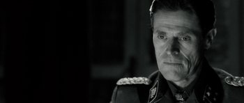 Movie still from “Adam Resurrected” (2008), directed by Paul Schrader – A person wearing a military uniform; Close Up shot, Over the shoulder angle