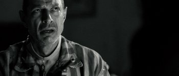 Movie still from “Adam Resurrected” (2008), directed by Paul Schrader – Black and white photograph of a man in a striped shirt; Close Up shot, Over the shoulder angle