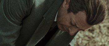 Movie still from “Adam Resurrected” (2008), directed by Paul Schrader – A person wearing a suit and tie; Close Up shot, High angle