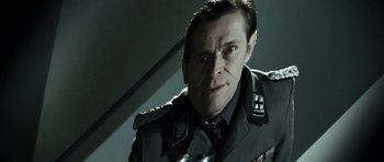 Movie still from “Adam Resurrected” (2008), directed by Paul Schrader – A person wearing a uniform; Close Up shot, Low angle