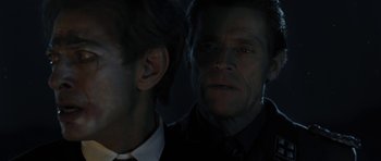 Movie still from “Adam Resurrected” (2008), directed by Paul Schrader – A man in a black shirt and a man in a white shirt; Close Up shot, Over the shoulder angle