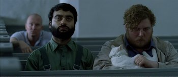 Movie still from “Adam's Apples” (2005), directed by Anders Thomas Jensen – Two men sitting next to each other on a bench; Close Up shot, Low angle