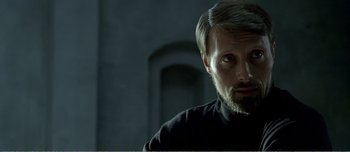 Movie still from “Adam's Apples” (2005), directed by Anders Thomas Jensen – A person wearing a black shirt; Close Up shot, Over the shoulder angle