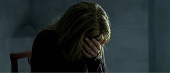 Movie still from “Adam's Apples” (2005), directed by Anders Thomas Jensen – A woman with her hands covering her face; Close Up shot, High angle