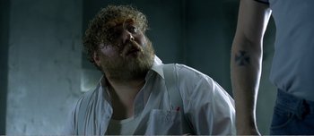 Movie still from “Adam's Apples” (2005), directed by Anders Thomas Jensen – A man with a beard and a white shirt is looking up; Close Up shot, Low angle