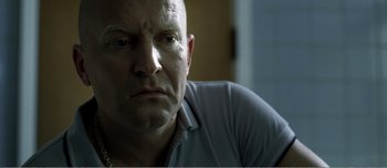 Movie still from “Adam's Apples” (2005), directed by Anders Thomas Jensen – A person looking at the camera; Close Up shot, Low angle