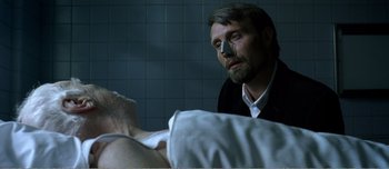 Movie still from “Adam's Apples” (2005), directed by Anders Thomas Jensen – A man looking at another man in a hospital bed; Close Up shot, Over the shoulder angle