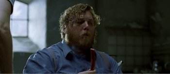 Movie still from “Adam's Apples” (2005), directed by Anders Thomas Jensen – A man holding a hot dog in his mouth; Close Up shot, Low angle