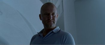 Movie still from “Adam's Apples” (2005), directed by Anders Thomas Jensen – A man with a bald head wearing a blue shirt; Close Up shot, Low angle