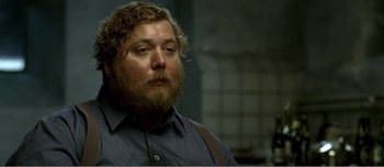 Movie still from “Adam's Apples” (2005), directed by Anders Thomas Jensen – A person with a beard wearing a blue shirt; Close Up shot, High angle