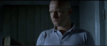 Movie still from “Adam's Apples” (2005), directed by Anders Thomas Jensen – A man with bald head looking at the camera; Close Up shot, Low angle