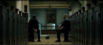 Movie still from “Adam's Apples” (2005), directed by Anders Thomas Jensen – Two men sitting on a bench in front of each other; Wide shot, Low angle