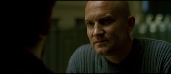 Movie still from “Adam's Apples” (2005), directed by Anders Thomas Jensen – A man with a bald head looking into a mirror; Close Up shot, Over the shoulder angle