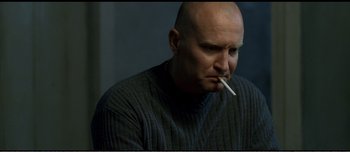 Movie still from “Adam's Apples” (2005), directed by Anders Thomas Jensen – A bald man with a cigarette in his mouth; Close Up shot, High angle