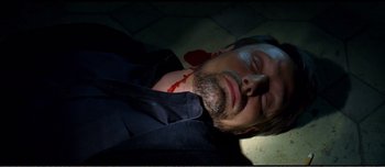 Movie still from “Adam's Apples” (2005), directed by Anders Thomas Jensen – A man with blood on his face is laying on the floor; Close Up shot, Overhead angle
