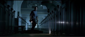 Movie still from “Adam's Apples” (2005), directed by Anders Thomas Jensen – A man is walking in the dark holding a flashlight; Wide shot, Low angle
