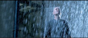 Movie still from “Adam's Apples” (2005), directed by Anders Thomas Jensen – A man standing in the pouring rain looking up at the sky; Close Up shot, Low angle